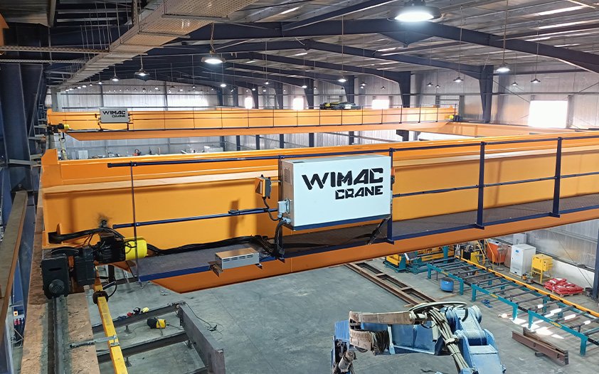 Double girder overhead crane end carriage with forged steel wheels and VFD-controlled long-travel drive on runway rails